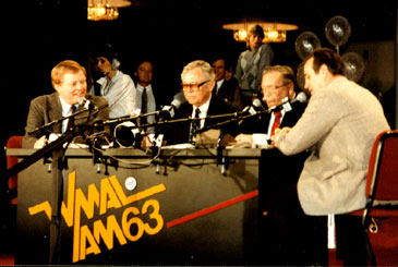 Some photos taken by Neal Conway at the 1985 celebration of 25th Anniversary of Harden & Weaver's WMAL morning show. Above: Frank Harden and Jack Weaver with Sonny Jurgenson and Sam Huff. Right: Bill Mayhugh stops by with Montgomery Donuts.